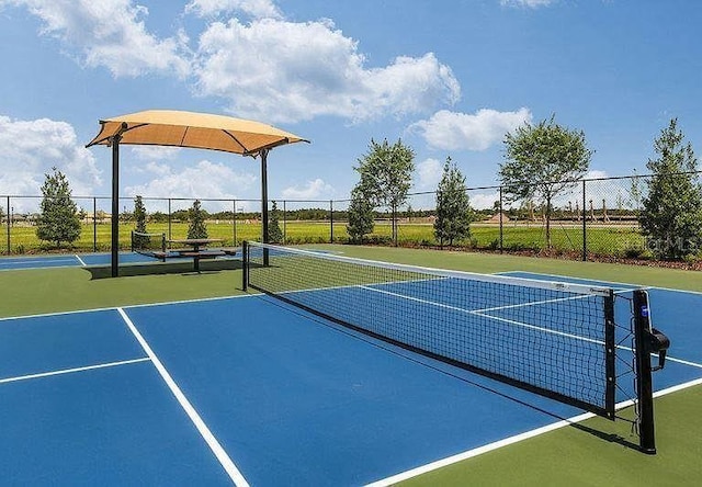 view of tennis court featuring basketball court