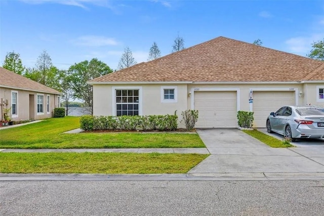 ranch-style home featuring a front yard, an attached garage, concrete driveway, and stucco siding