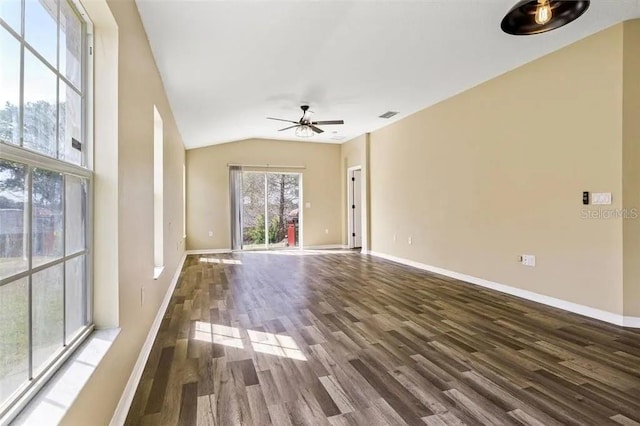 unfurnished living room featuring dark hardwood / wood-style flooring, vaulted ceiling, and ceiling fan