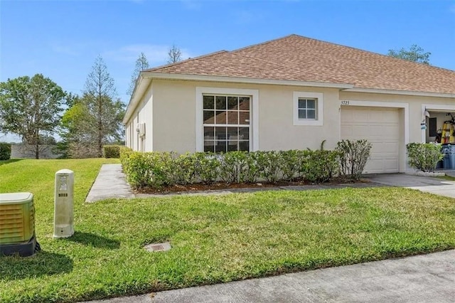 view of property exterior featuring a yard, central AC unit, and a garage