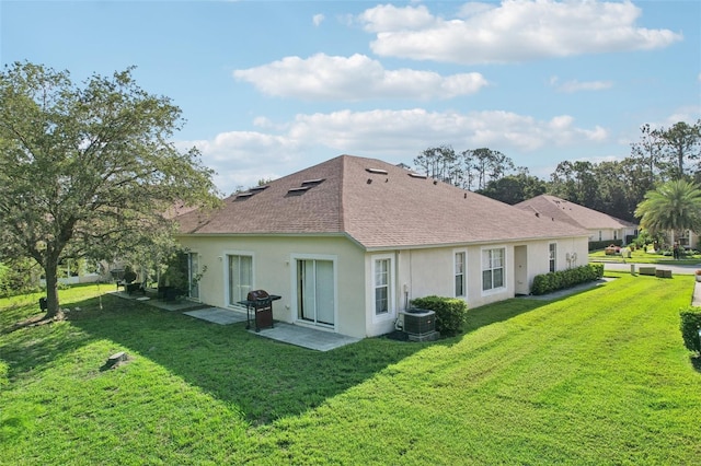 back of property with a lawn and central AC unit