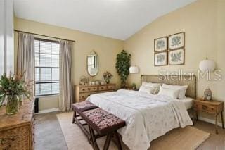 bedroom featuring vaulted ceiling