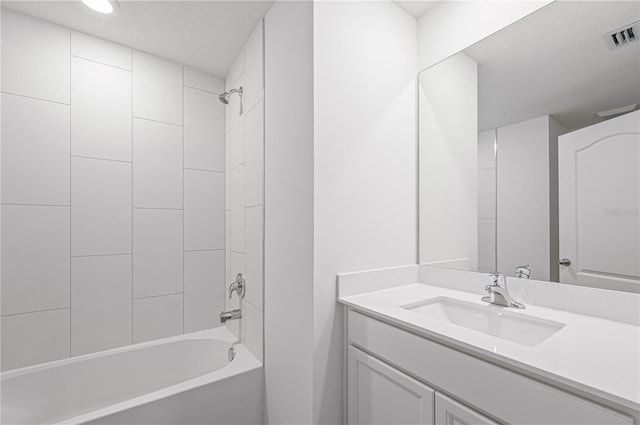 bathroom with visible vents, vanity, and  shower combination