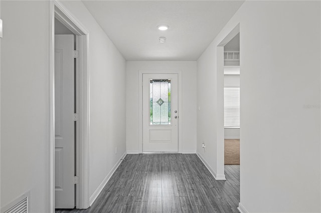 foyer entrance with dark wood-style flooring, baseboards, and visible vents