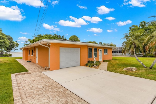 ranch-style home with a garage and a front yard