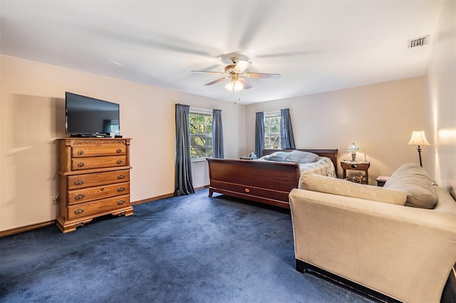 bedroom featuring visible vents, ceiling fan, baseboards, and dark colored carpet