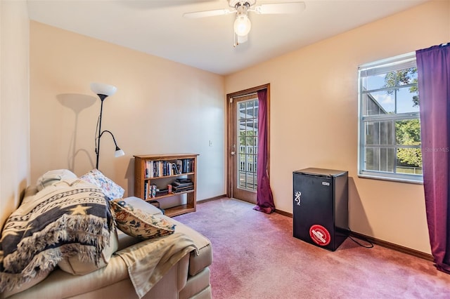 sitting room featuring ceiling fan, baseboards, and carpet floors