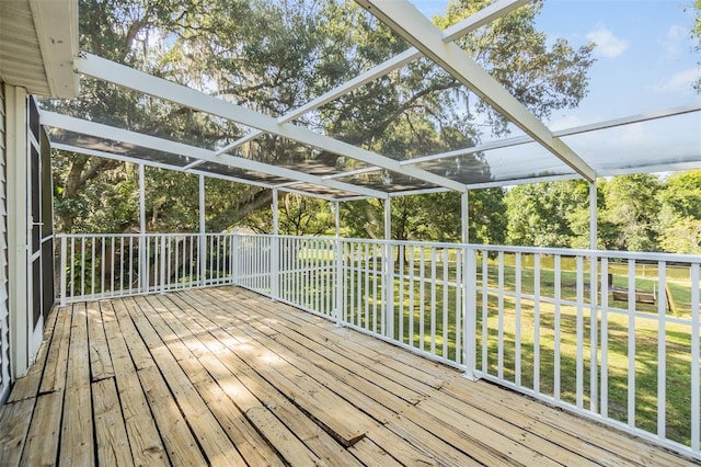 wooden terrace with glass enclosure and a lawn