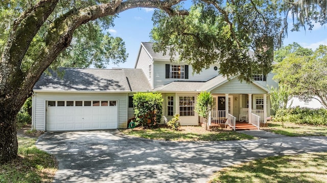 view of front of house featuring aphalt driveway, a garage, and roof with shingles