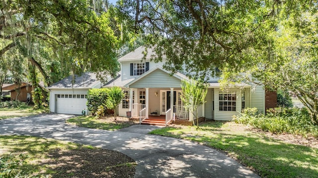 view of front of property with covered porch, driveway, and a garage