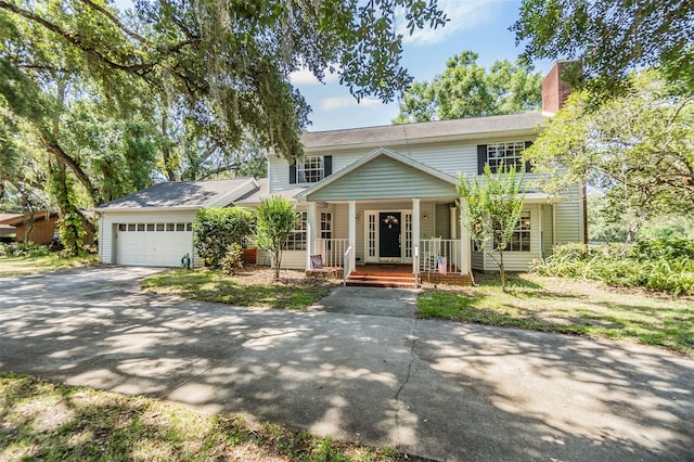 view of front of property featuring a porch, an attached garage, and concrete driveway