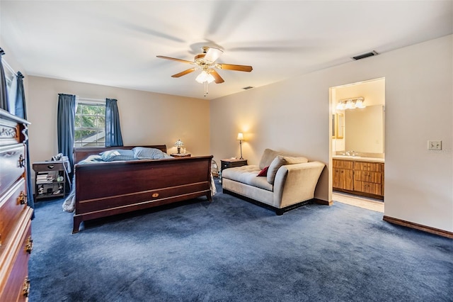 carpeted bedroom with visible vents, a ceiling fan, a sink, connected bathroom, and baseboards