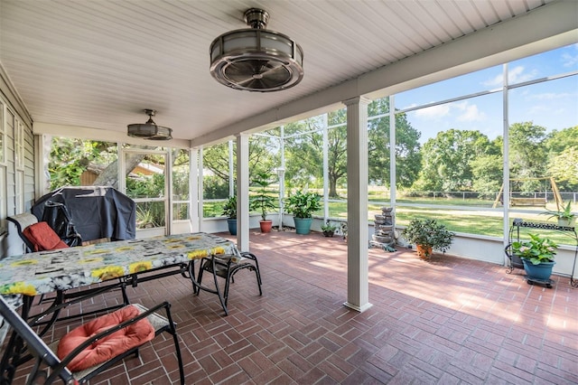 sunroom / solarium featuring a ceiling fan