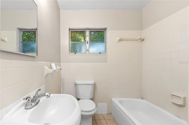 bathroom featuring sink, tile patterned floors, plenty of natural light, toilet, and tile walls