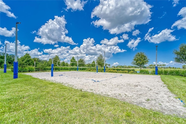 view of home's community featuring volleyball court and a yard