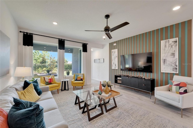 living room with ceiling fan and light hardwood / wood-style floors