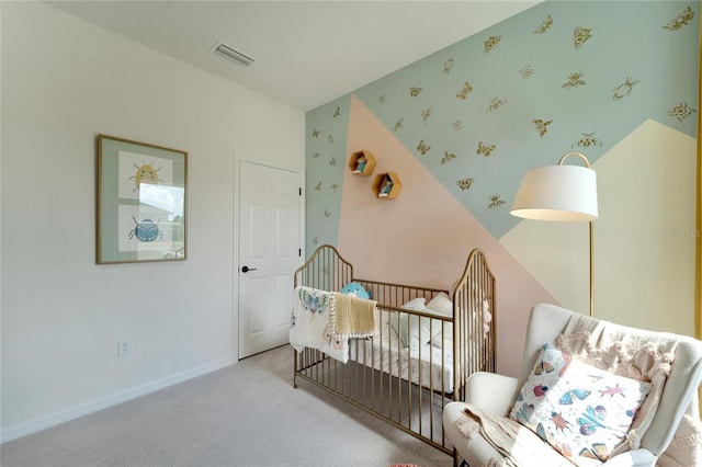 bedroom with light carpet and a nursery area