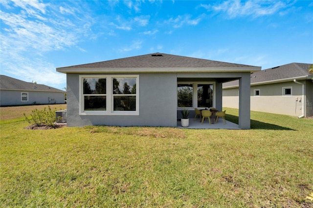 back of property featuring a patio area and a yard