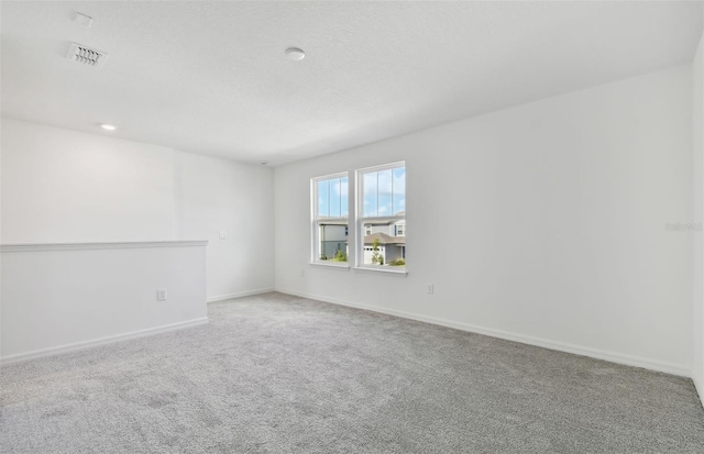 unfurnished room featuring light colored carpet