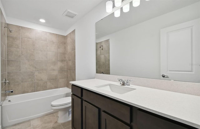 full bathroom featuring toilet, vanity, tiled shower / bath combo, and tile patterned floors