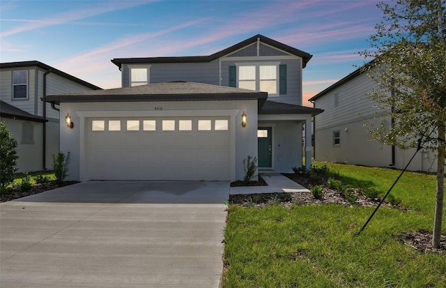 view of front of house with a lawn and a garage