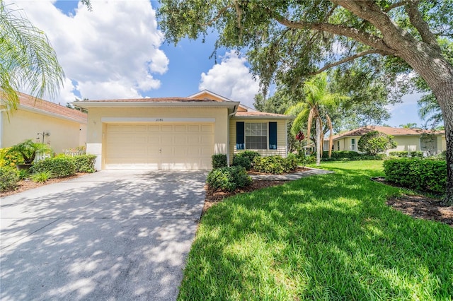 view of front of house with a front yard and a garage