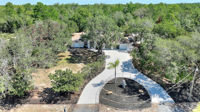 drone / aerial view featuring a wooded view