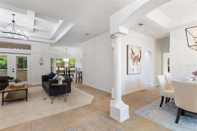 interior space with a wealth of natural light, ornate columns, coffered ceiling, and a chandelier