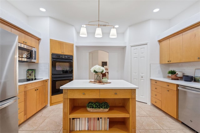 kitchen with light tile flooring, a kitchen island, black appliances, and backsplash