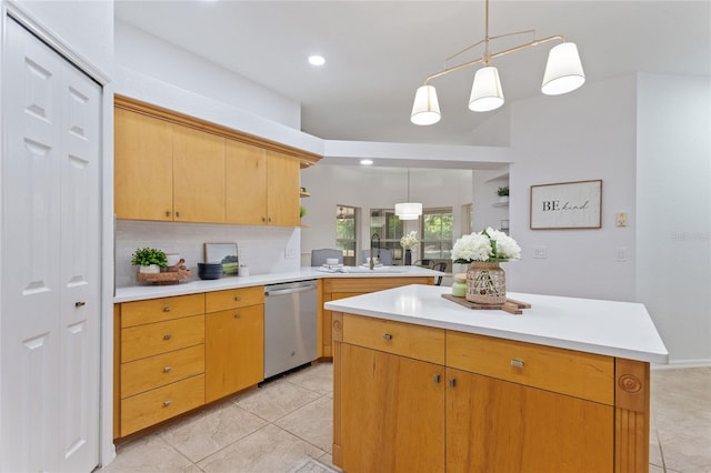 kitchen featuring stainless steel dishwasher, pendant lighting, a kitchen island, light tile floors, and sink