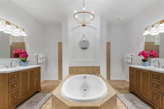 bathroom with a relaxing tiled bath, tile flooring, a notable chandelier, and double sink vanity