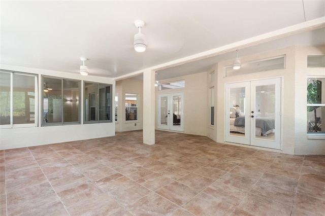 interior space featuring ceiling fan and french doors