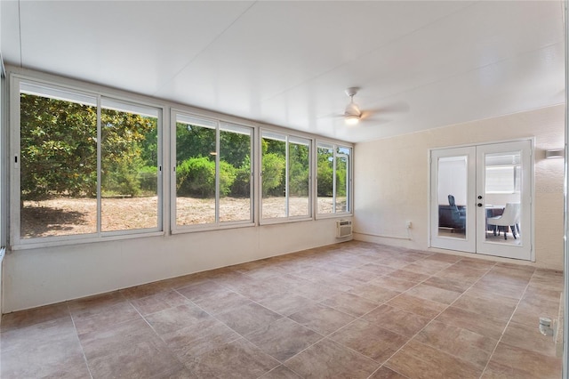 unfurnished sunroom featuring ceiling fan and french doors