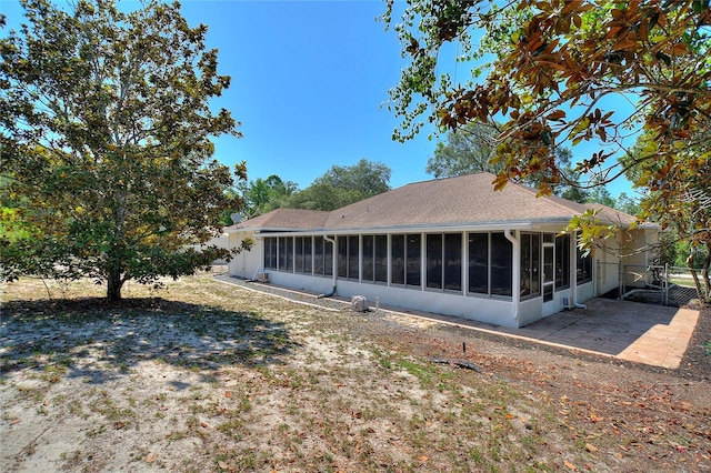 rear view of property with a sunroom