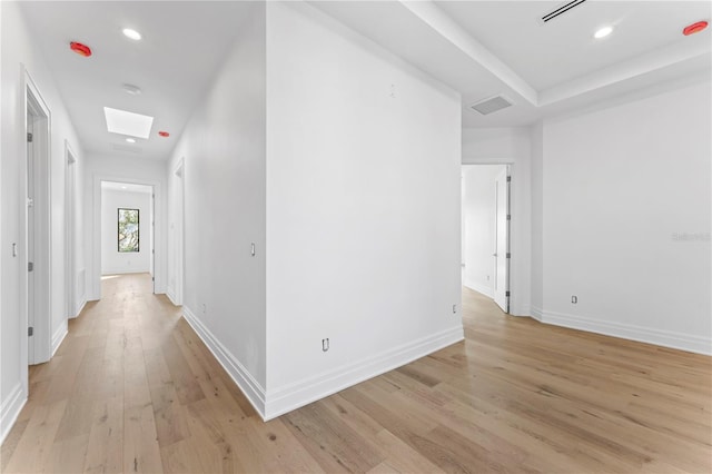 hall with recessed lighting, visible vents, light wood-style flooring, and baseboards