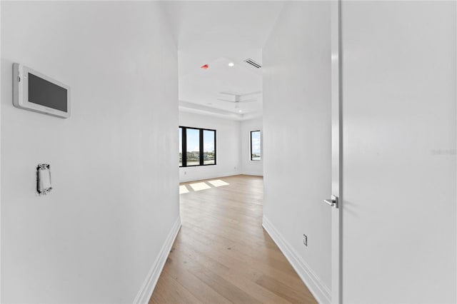 hallway featuring visible vents, light wood-style flooring, recessed lighting, and baseboards