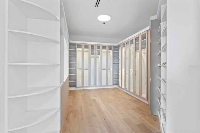 spacious closet with visible vents and wood finished floors