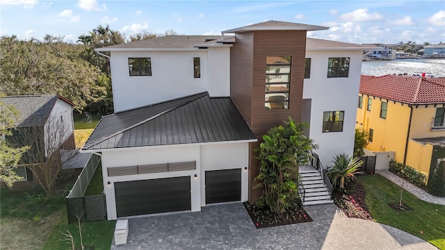 contemporary home featuring decorative driveway and stucco siding