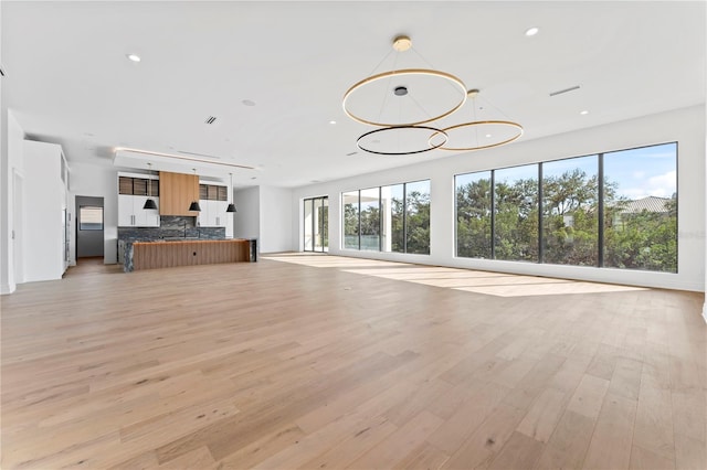 unfurnished living room featuring recessed lighting, visible vents, and light wood-style flooring