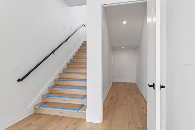 stairs featuring recessed lighting, baseboards, and wood finished floors