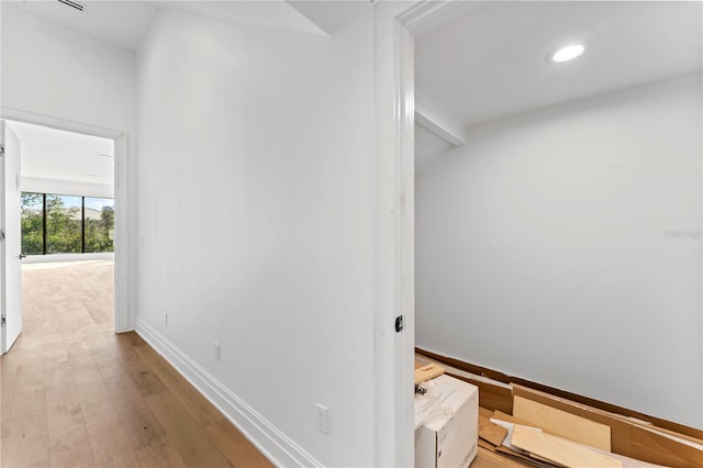 hallway featuring recessed lighting, baseboards, and wood finished floors