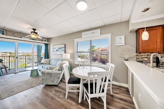 dining area with ceiling fan, wood finished floors, and plenty of natural light