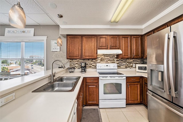 kitchen featuring a paneled ceiling, light tile flooring, backsplash, sink, and white appliances