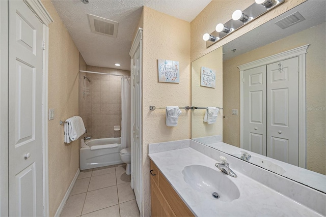 full bathroom featuring toilet, tile floors, shower / bath combination with curtain, vanity, and a textured ceiling