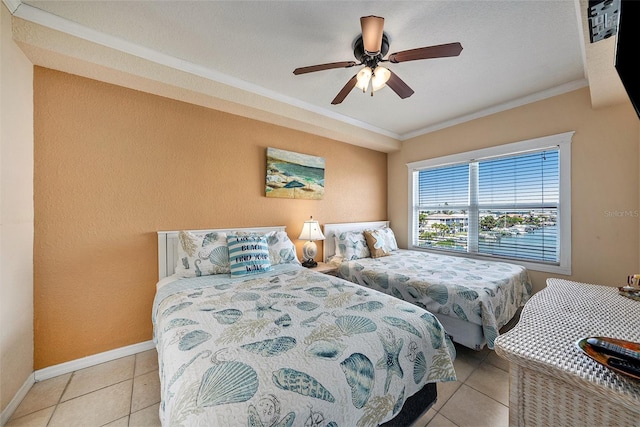 bedroom with baseboards, a ceiling fan, tile patterned floors, and crown molding