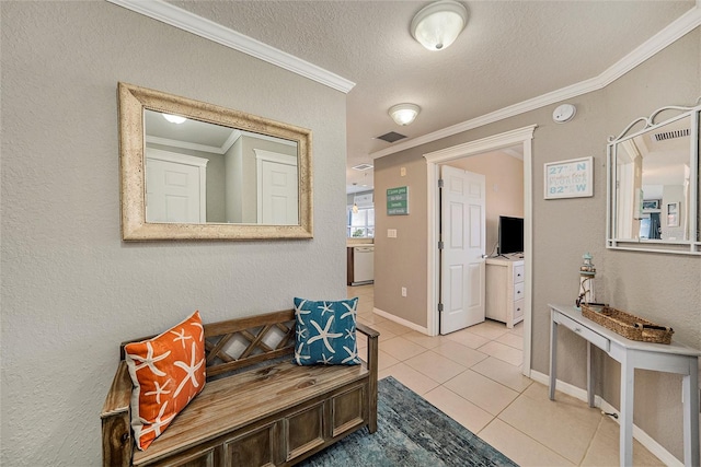 foyer featuring light tile flooring, a textured ceiling, and crown molding