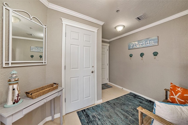 foyer featuring a textured ceiling, ornamental molding, visible vents, and a textured wall