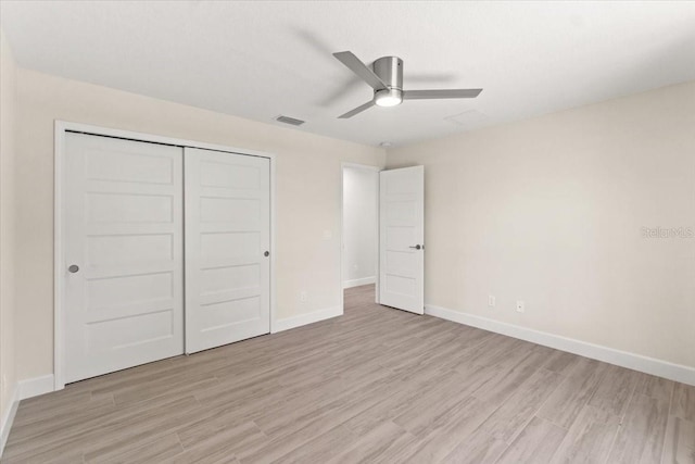 unfurnished bedroom with ceiling fan, a closet, and light hardwood / wood-style floors