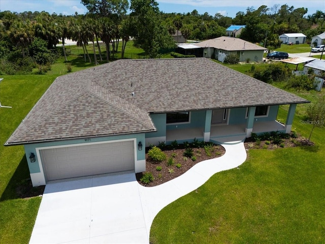 single story home featuring covered porch, a garage, and a front lawn