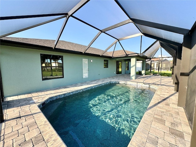 view of swimming pool with a lanai and a patio area